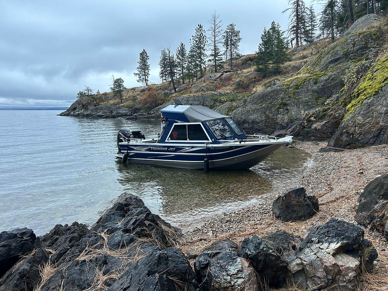 The Okanagan Bucktail Co. boat on the Okanagan Lake shoreline under open sky