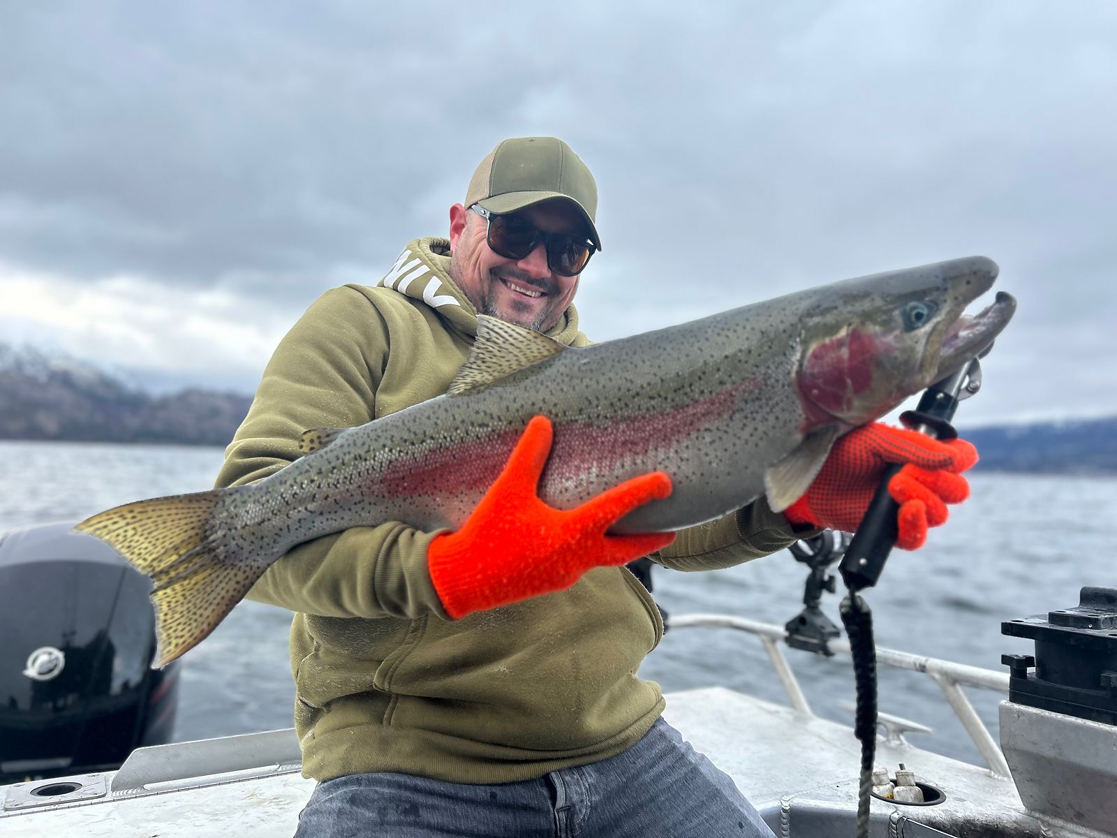 A heavy Okanagan Lake rainbow trout held up on the boat